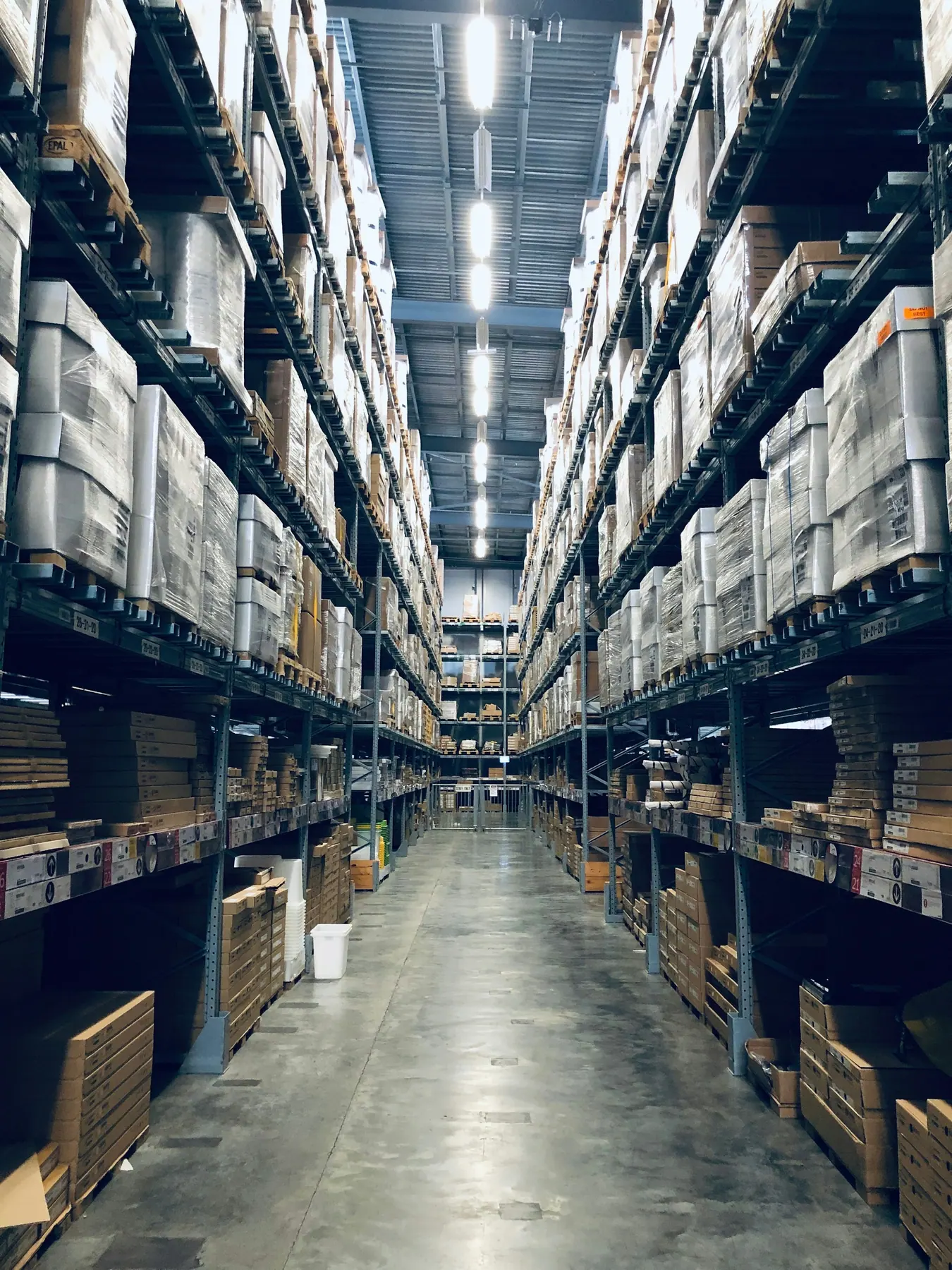 Warehouse shelves stacked with wrapped pallets