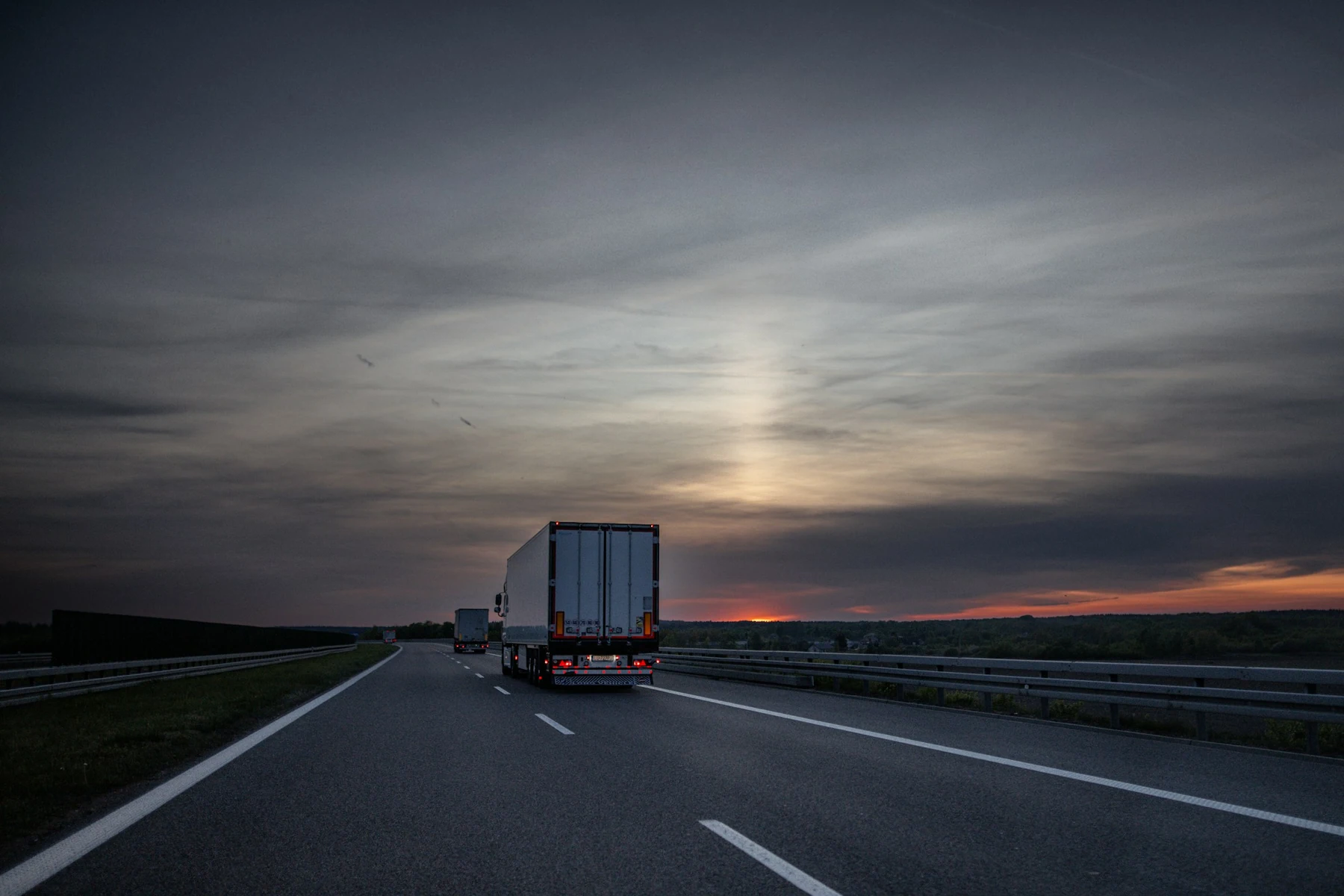 A lorry on a motorway at sunset