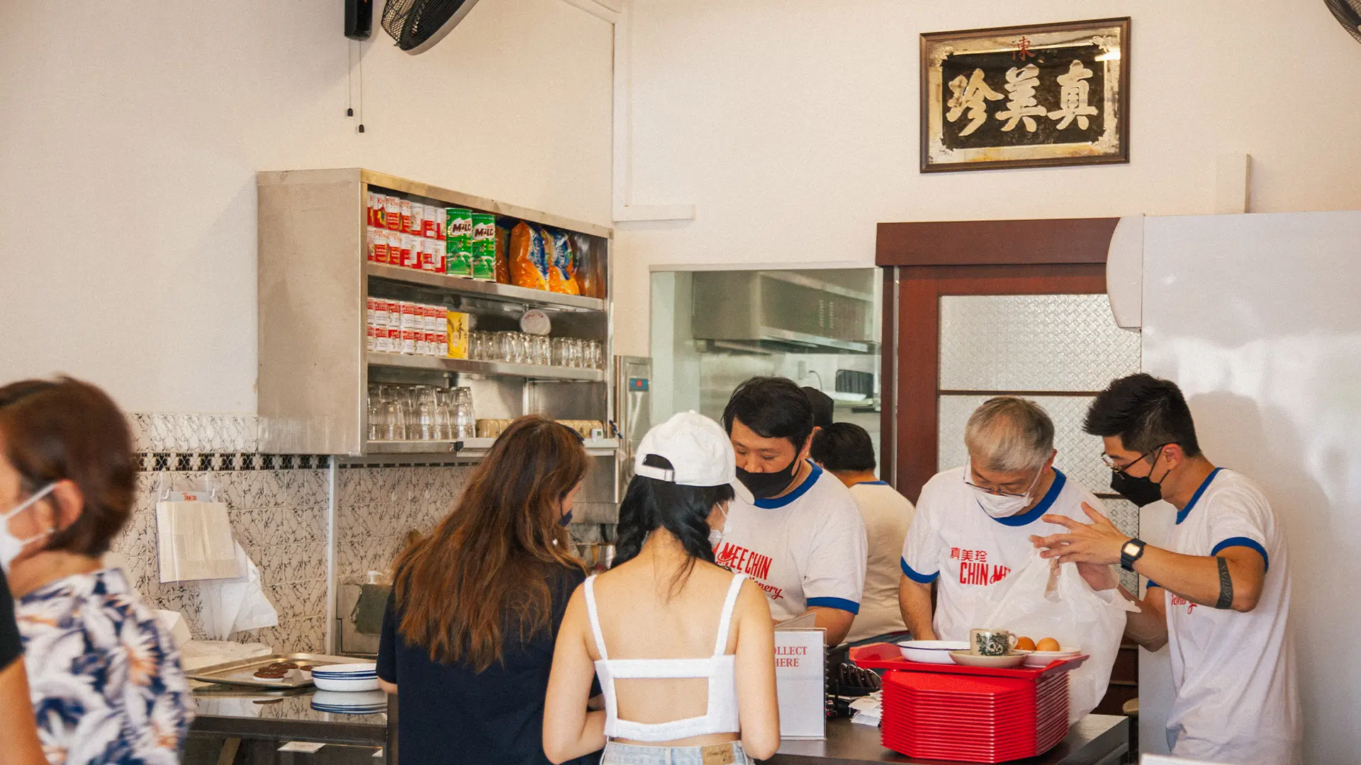 Customers queuing at a traditional kopitiam counter